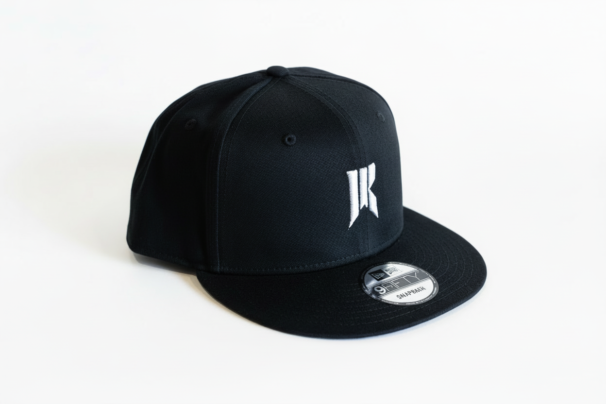 Black Rebellion x New Era snapback hat with white embroidered logo on a white background